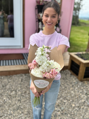 Woman holding a bouquet of flowers outdoors