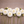 White Brookside Snowball dahlia flowers with green stems arranged on a wooden surface