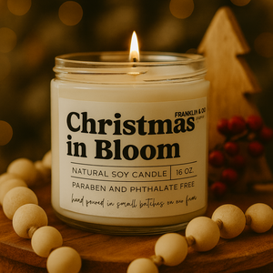 Candle labeled 'Christmas in Bloom' with a blurred festive background