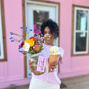 Girl holding an ice cream cone and a mason jar of farm fresh flowers at Franklin & Co. Flower Farm in Charlie Lake BC